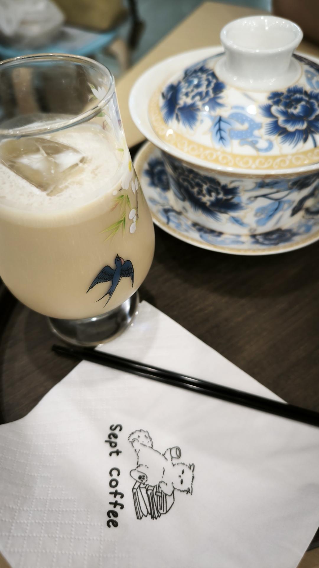 two cups, 1 with white liquid the other covered porcelain