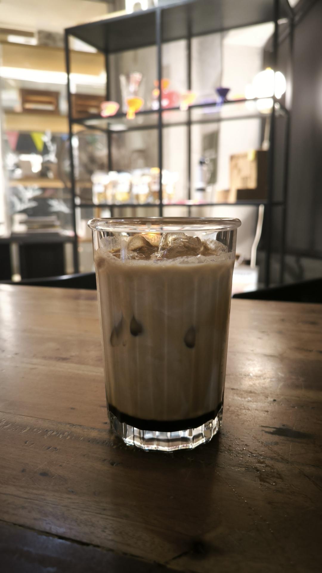 iced coffee on a table in a dimly lit room