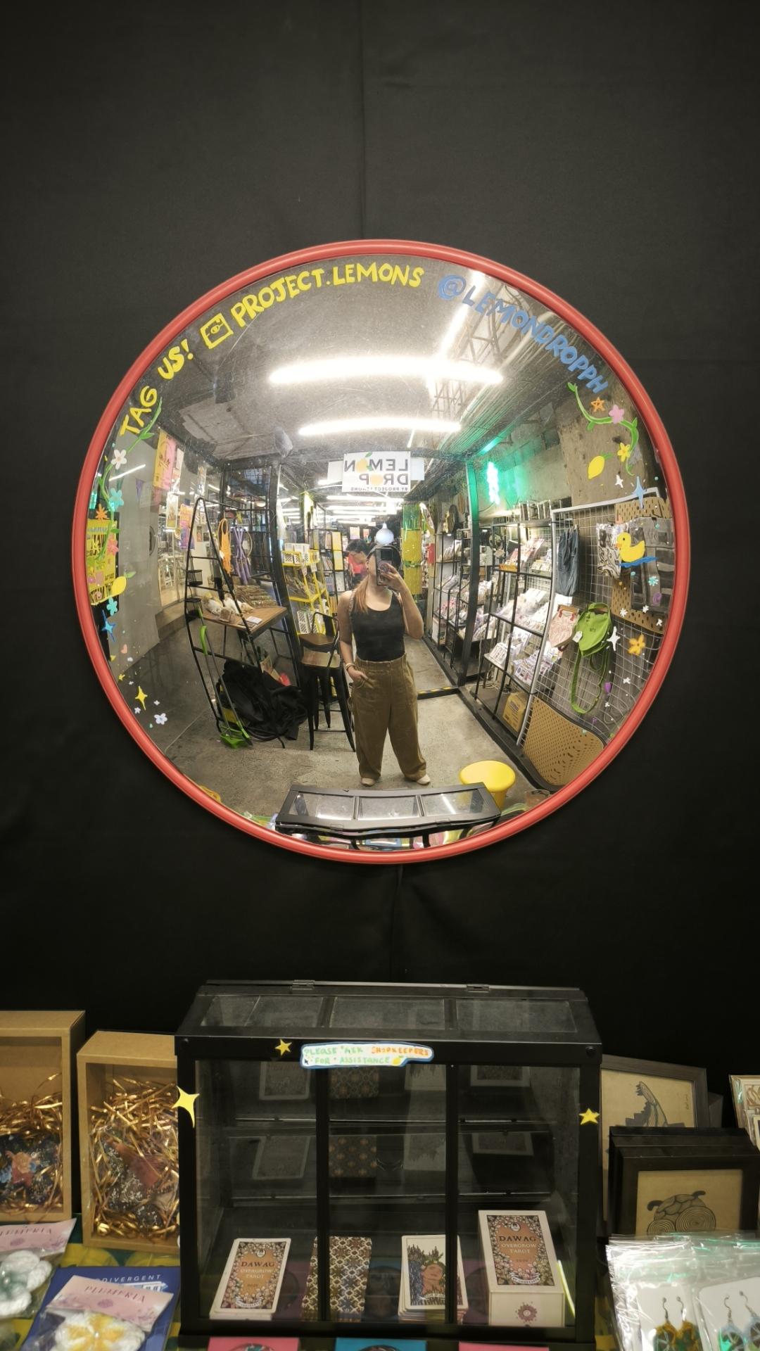 convex mirror selfie in one of the stores